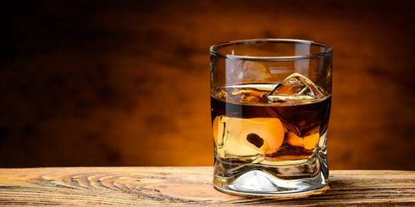 (A glass of Scotch whisky on an oak table, with a large cube of ice) The question of how to drink whisky has many answers, but the best is 'however you like'