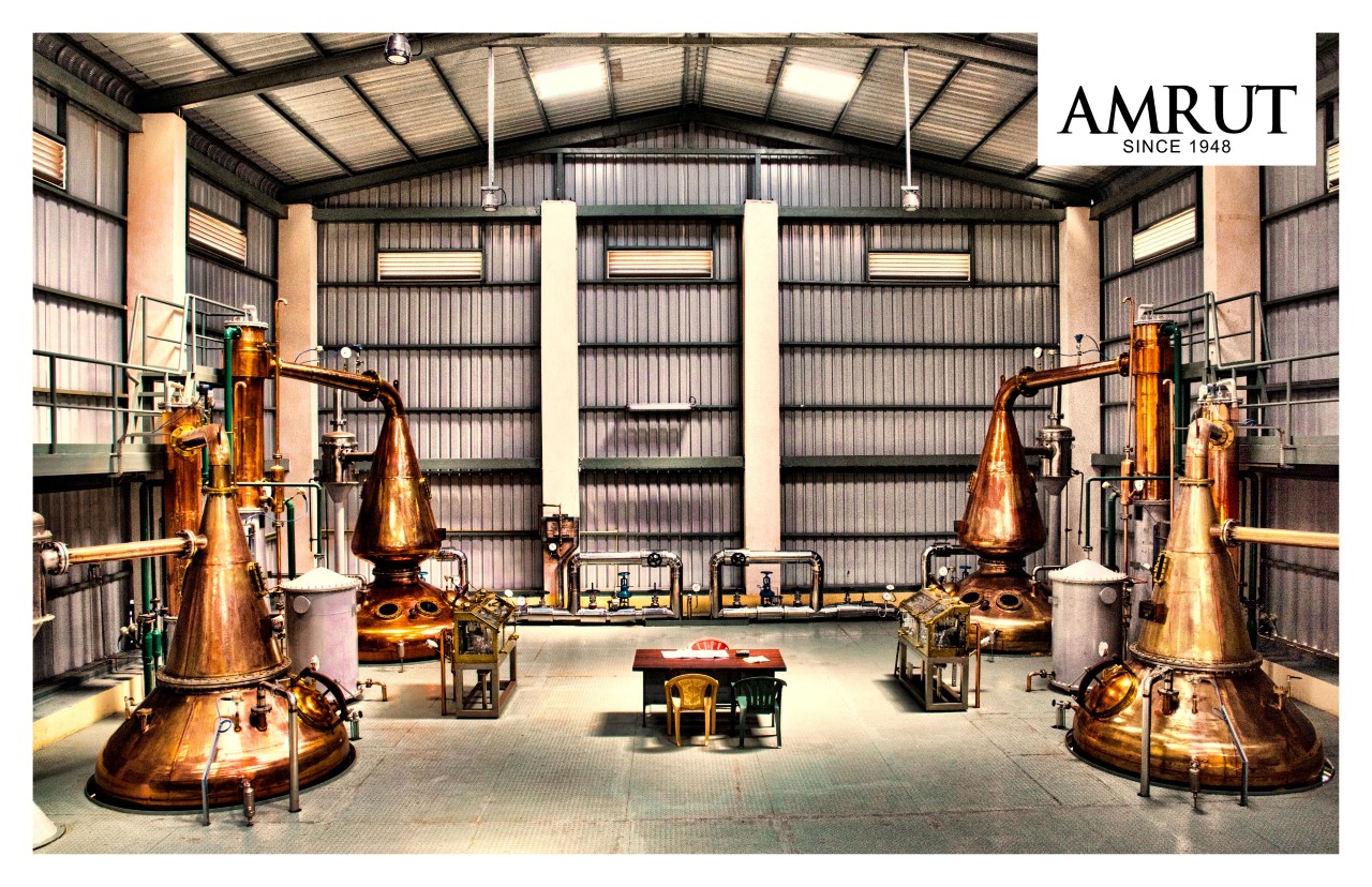 (stills at Amrut distillery) Amrut and other Indian distillers benefit from the high Scotch tariffs at home, but feel they're being held back in Europe