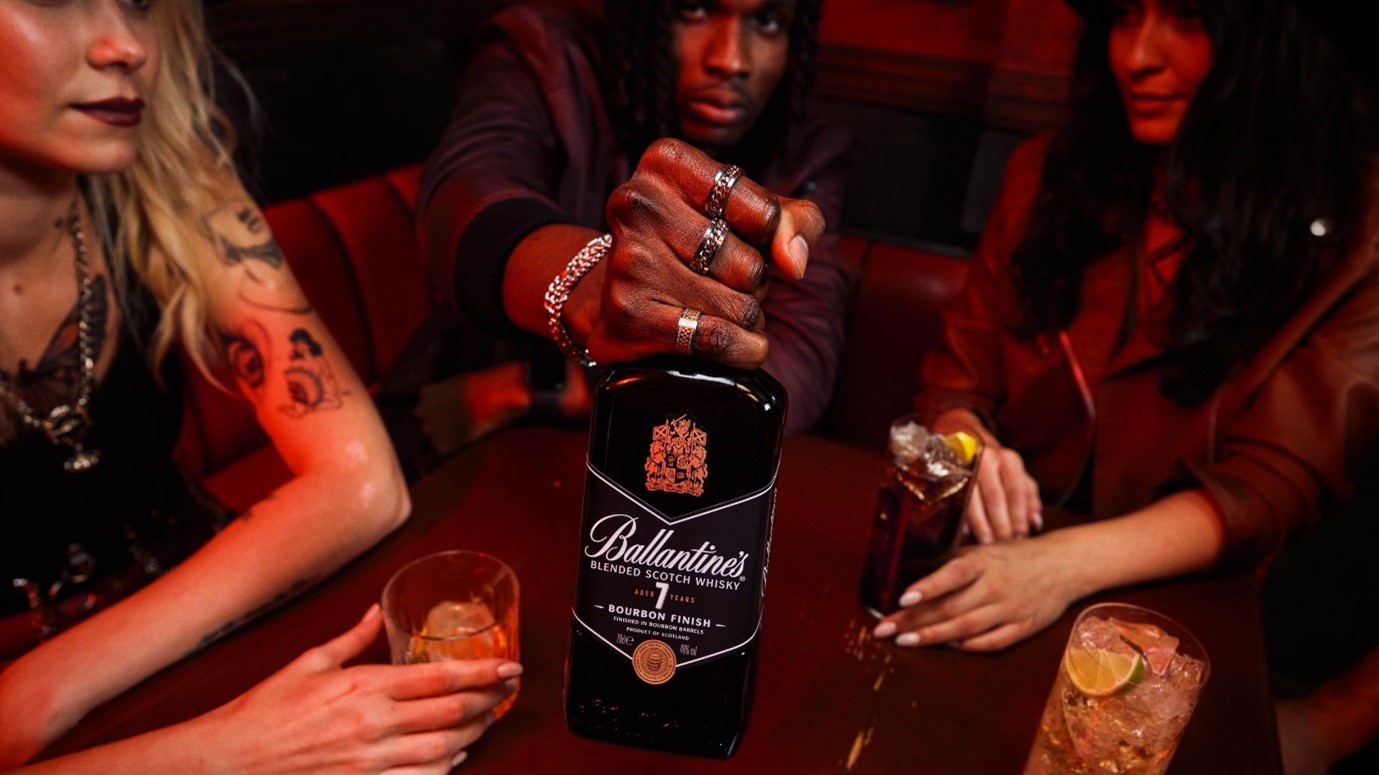 (Several people drinking Ballantine's 7yo) Ballantines is one of several blends trying to break open a niche between value and premium