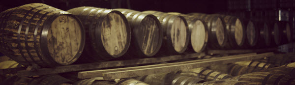 Casks of whisky maturing in a Scottish warehouse