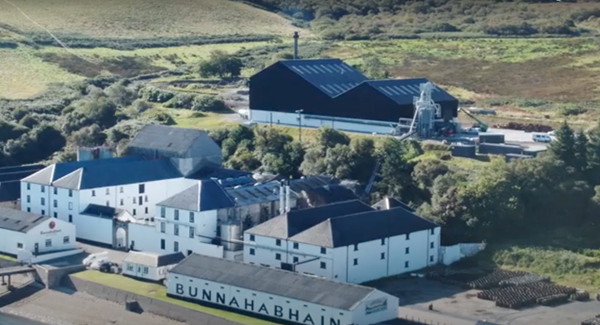 Aerial shot of Bunnahabhain distillery, white stone buildings with grey roofs
