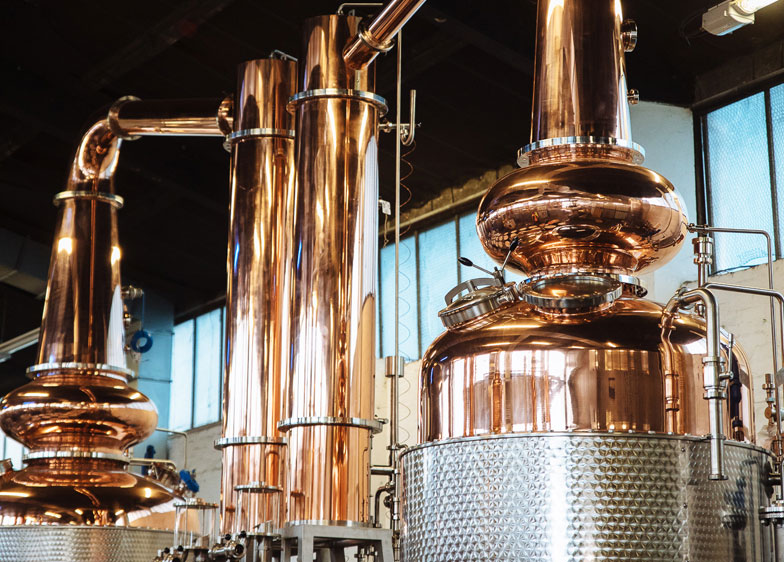 (image of stills at the Glasgow Distillery) Scotch whisky's new urban distilleries are a shiny and bold revival of a bygone era