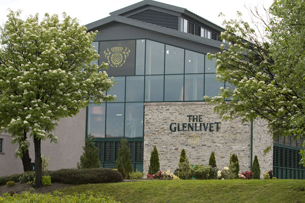 (An external shot of Glenlivet distillery, framed by trees in bloom) The Glenlivet has risen from a wee brand and a couthy distillery to be the world's leading single malt Scotch whisky