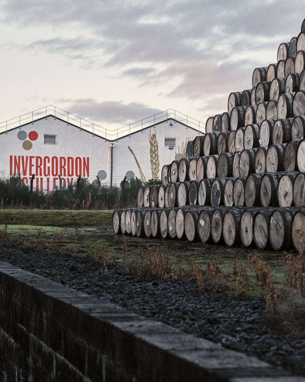 (Whisky casks stacked outside Invergordon distillery) Invergordon's approach is to let the liquid do the talking, more than trying to build a brand