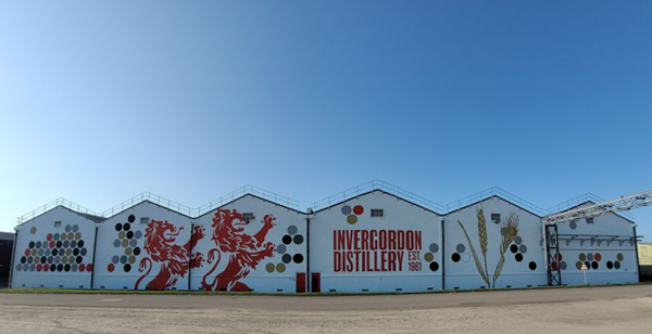 (External shot of Invergordon distillery, six connected buildings with a twin rampant lions logo in red)