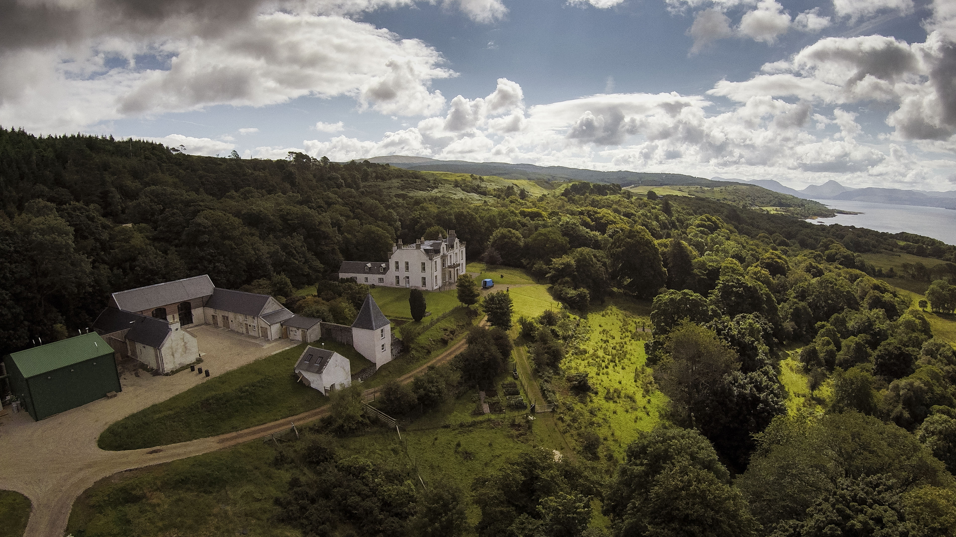 (An aerial shot of Nc'nean distillery) Nc'nean's lush surroundings go hand in hand with its drive towards sustainability and preservation