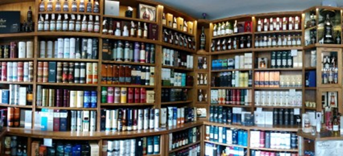 (image of Royal Mile Whiskies, interior shelves) The well-stocked shelves at Royal Mile are increasingly filled with smaller brands
