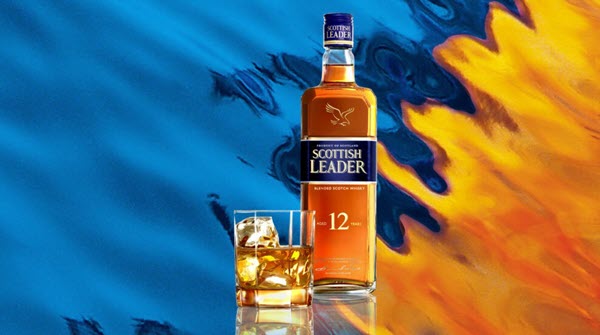 An advert for Scottish Leader 12yo, showing the bottle on a blue and orange background evoking sunrise on the sea