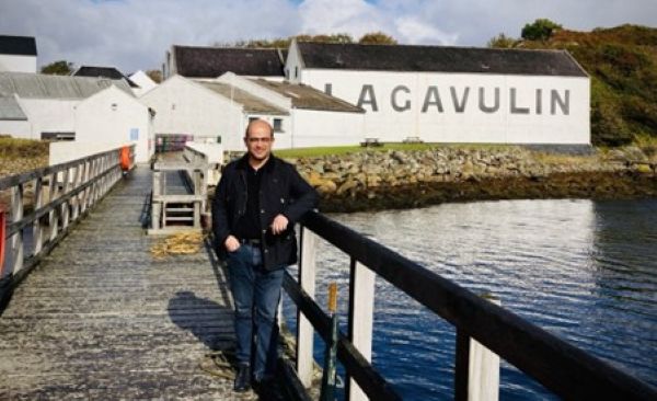 Kedar Ulman standing outside of Lagavulin distillery in Scotland