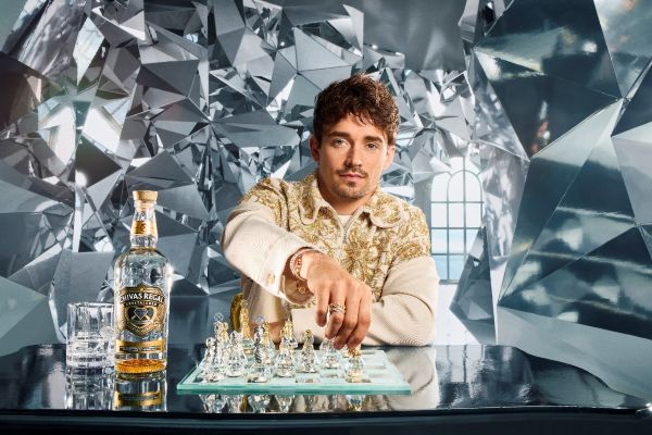 Brand ambassador Charles Leclerc playing chess with a bottle of Chivas Regal