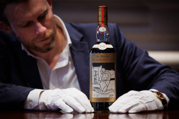 Jonny Fowle, Sotheby's Global Head of Spirits, with the Macallan 1926.