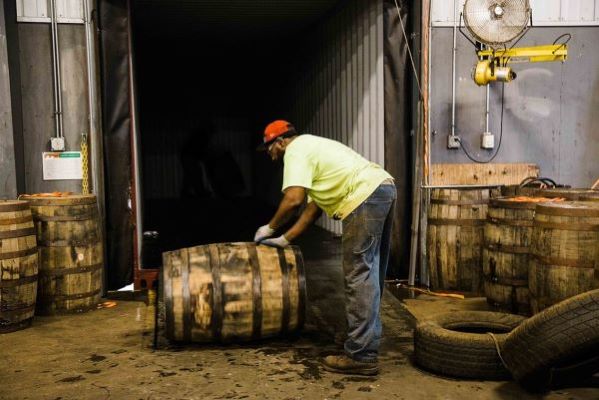 Image of a Man Moving a Cask