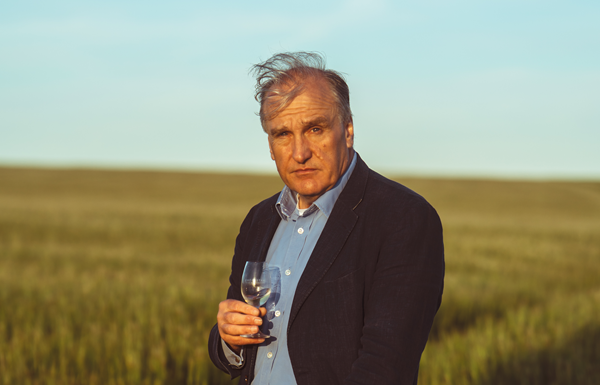 Waterford CEO Mark Reynier in front of a field of barley